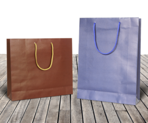 Colourful paper shopping bags on wooden floor isolated with clipping path for mockup