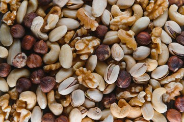 Background of various nuts almond, cashew, hazelnut, pistachio, walnut. Vegetarian meal. Healthy eating concept
