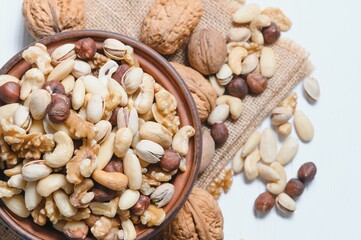 Mixed nuts on a plate. White background