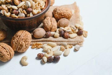Mixed nuts on a plate. White background