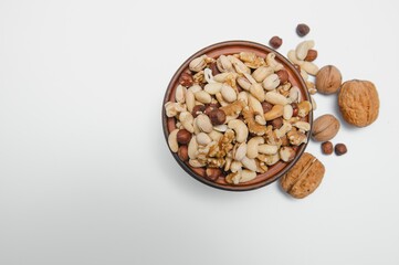 Mixed nuts on a plate. White background
