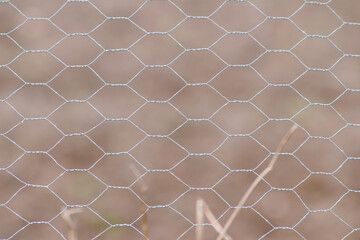 Barb wire-mesh fencekeep livestock on the farmland and shows no trespassing for unauthorized people...