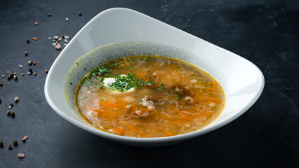 Cabbage soup with potatoes, carrots, pork, greens and sour cream.
