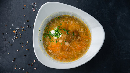 Hot cabbage soup with potatoes, carrots, pork, greens and sour cream.