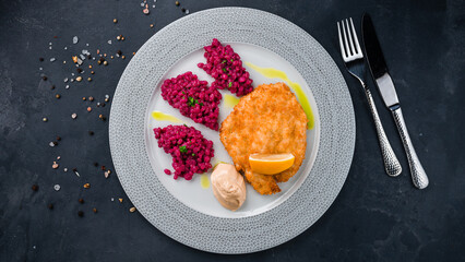 Lunch fried chicken fillet with rice in beetroot sauce.