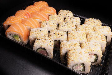 Sushi set in a plastic container with salmon, tuna, Japanese cuisine