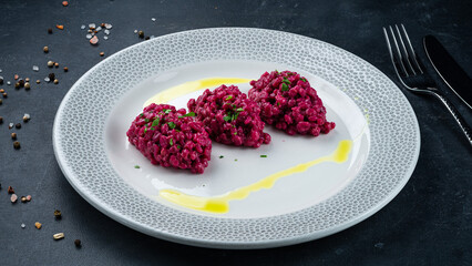Garnish rice in beetroot sauce on plate.