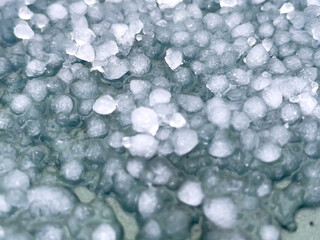 Large hailstones on a dark background. background, texture. Close-up.