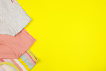 colored baby panties on a yellow background
