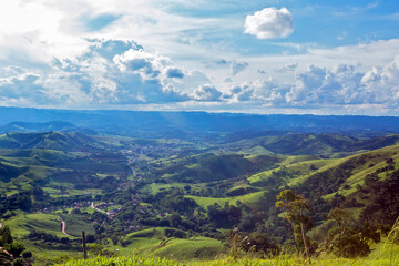 Fototapeta na wymiar Small town nestled among the green hills of Serra da Mantiqueira in the state of Minas Gerais, Brazil