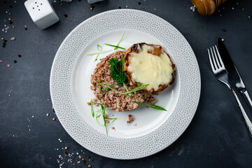 Buckwheat with pork steak, cheese and herbs.