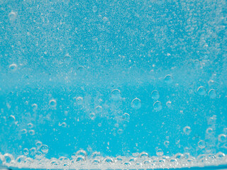 Air bubbles in water. Blue water with air bubbles. Close-up.
