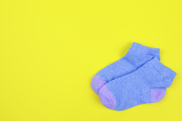Pair of children's socks on a yellow background