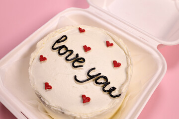 Trendy bento cake delicate biscuit with the inscription love you close-up