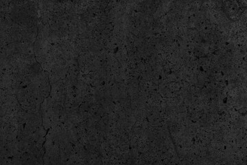 Fototapeta na wymiar Old cracked black concrete wall. Dark rough cement distressed texture. Gloomy grunge textured background