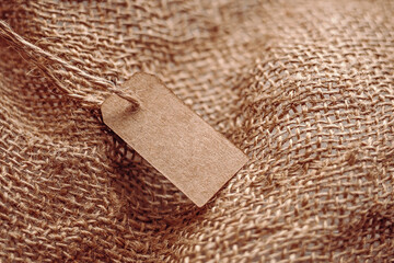 Craft tag with a lace on the background of burlap