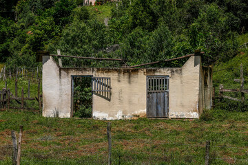 Abandoned farmhouse amidst the trees in countryside of Minas Gerais state. Brazil