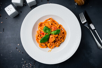 Pasta with tomatoes, tomato sauce and basil.
