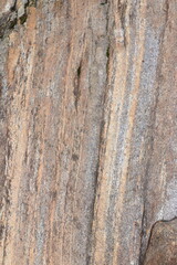 Gold brown and grey stone patterns with stripes from riverbed of Vale Verzasca in Switzerland
