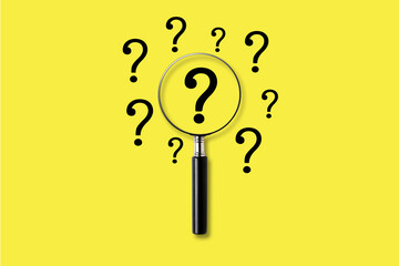 Fototapeta na wymiar Magnifying glass with question mark symbol. on a yellow background. Searching concept.