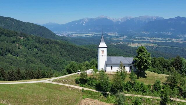Aerial morning view of St. Primoz church at Jamnik, Slovenia, Julian alps.