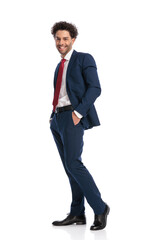 full body picture of happy young businessman posing with hands in pockets