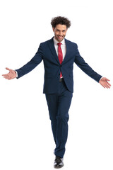 handsome young businessman with curly hair opening arms and welcoming