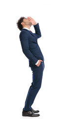 side view of curly hair arabic man with hand in pocket looking far away