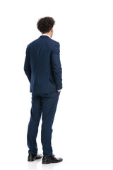 back view of curly hair elegant businessman holding hands in pockets