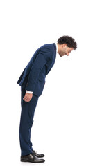 elegant young businessman looking down at something small on the floor