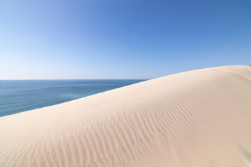 The sky, the sea and the sand dunes as a background. The beach El Asperillo, Huelva, Spain. Background for magazines.