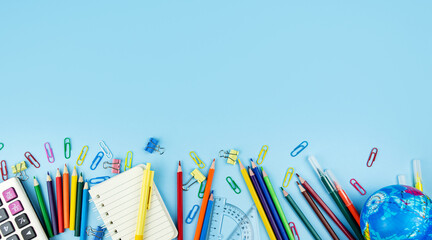 Back to school concept. School and office supplies on a blue background. He lay flat. Copy space.