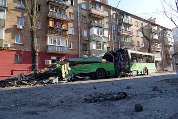 Fototapeta na wymiar Russian missile destroyed green trolleybus and houses in Kyiv, Ukraine