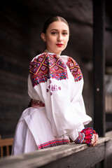 Fototapeta na wymiar Young beautiful slovak woman in traditional costume. Slovak folklore