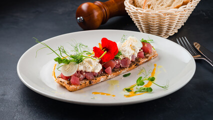 Tuna tartare with eggs, cream cheese on toast.