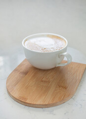 One large white cup of delicious fragrant cappuccino or latte coffee