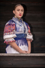 Fototapeta premium Young beautiful slovak woman in traditional costume. Slovak folklore