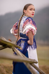 Young beautiful slovak woman in traditional dress. Slovak folklore