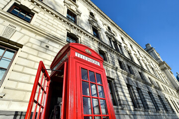 Main London symbols: red public telephone cabin nearby of Westminster Palace in Great Britain.