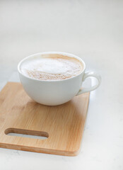 One large white cup of delicious fragrant cappuccino or latte coffee