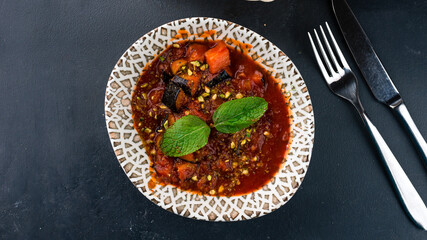 Sicilian cuisine caponata, vegetable stew with eggplant, tomatoes, onions, peppers, nuts.