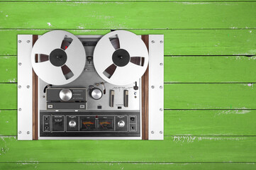 Vintage Music and sound - Retro reel to reel rack tapes recorder isolated green wooden background