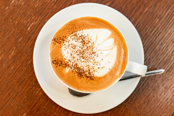 Cup of Cappuccino, top view. Coffee with milk foam and cinnamon