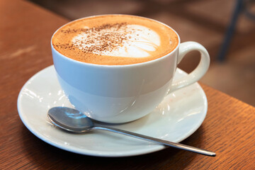 Cup of Cappuccino. Coffee with milk foam and cinnamon powder