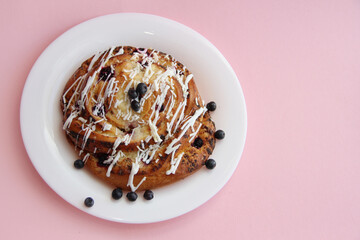 fresh pastries. currant pie is sprinkled with white chocolate. blueberry bun in white chocolate