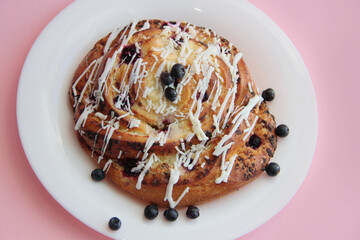 fresh pastries. currant pie is sprinkled with white chocolate. blueberry bun in white chocolate