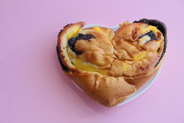 fresh pastries. heart-shaped pie with poppy seeds and lemon filling. a bun with lemon and poppy seeds.