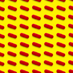 Gel capsule seamless pattern. Red capsule shaped medicine. pharmacy concept. food supplement. Capsule pills pattern on a yellow background