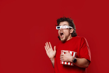 scared man in 3d-glasses holding bucket of popcorn