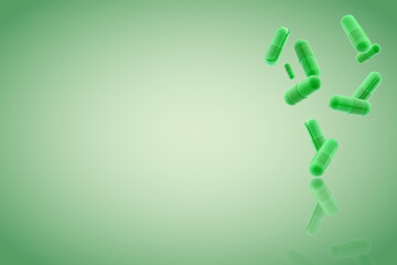 green medical gel capsules falling down on green background. food supplement, pharmacy concept. plastick capsules pills